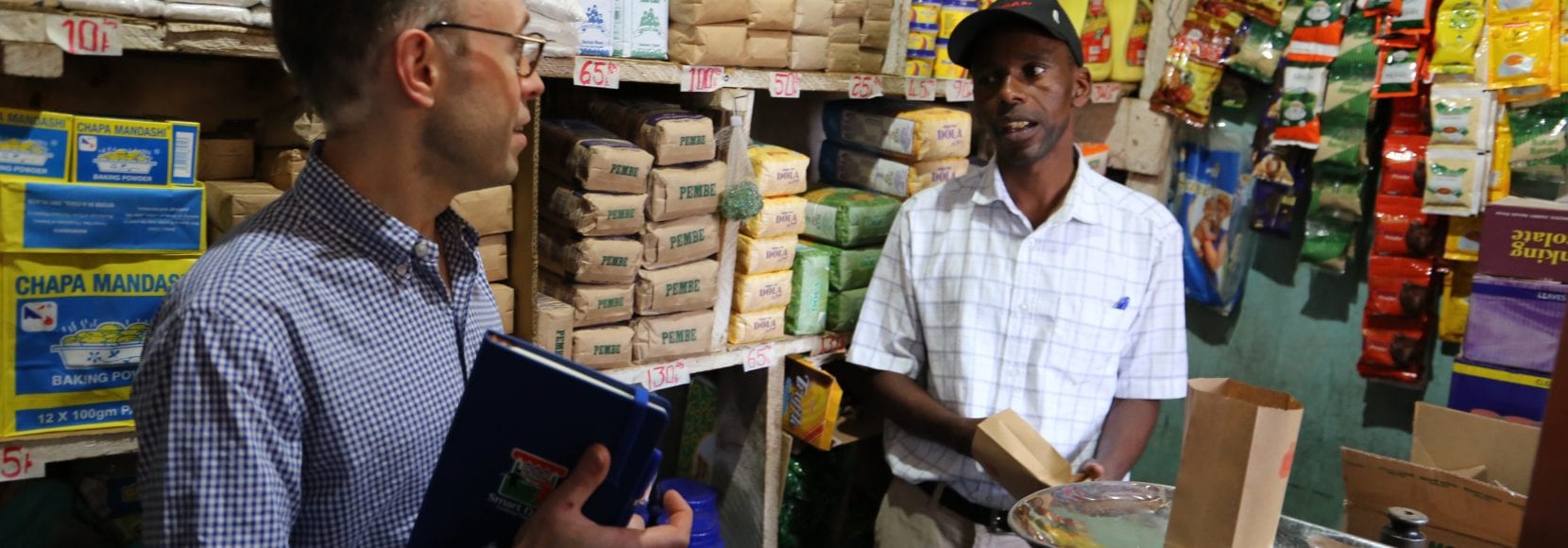 Two business men talking in a grocery store